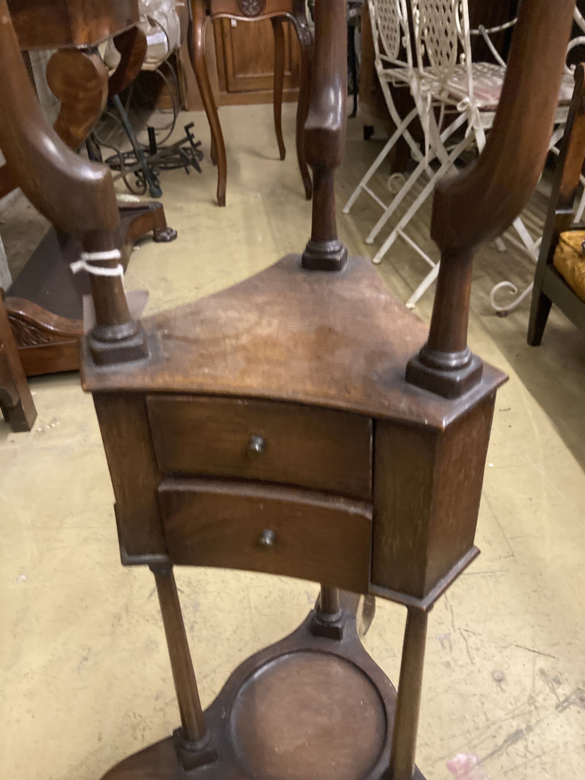 A George II style mahogany washstand, with open bowl stand over two triangular soap drawers and a jug platform, raised on cabriole legs